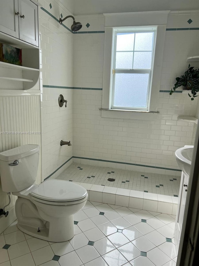 bathroom with tile patterned flooring, a shower stall, and toilet