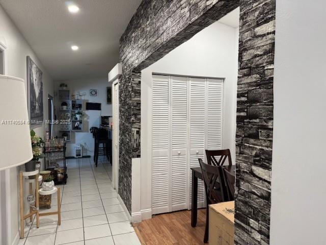 hall with light tile patterned floors