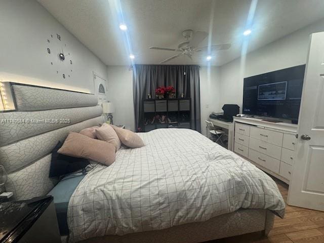 bedroom with wood-type flooring and ceiling fan