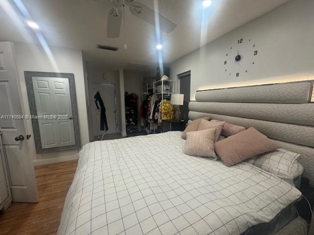 bedroom featuring ceiling fan and hardwood / wood-style floors