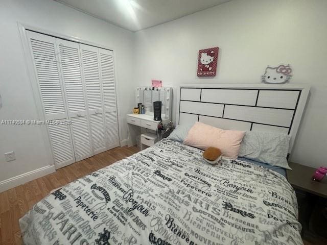 bedroom with hardwood / wood-style floors and a closet