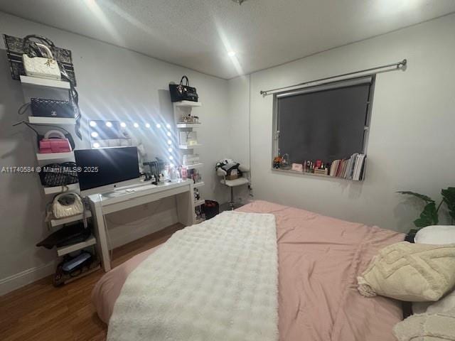 bedroom with hardwood / wood-style floors