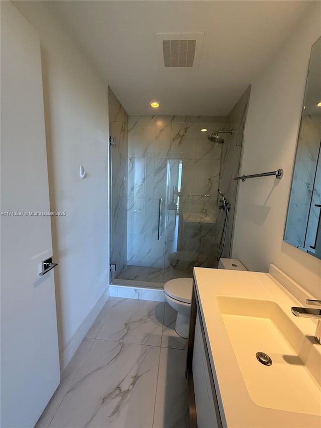 bathroom featuring vanity, toilet, and a shower with door