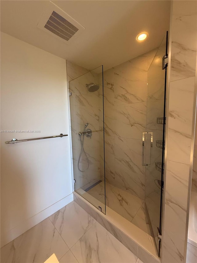 bathroom with a shower with door