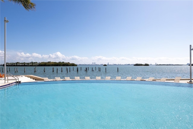 view of swimming pool with a water view