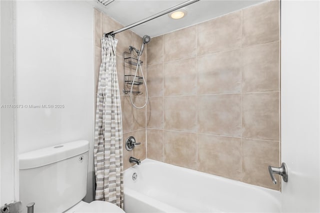 bathroom featuring shower / tub combo with curtain and toilet