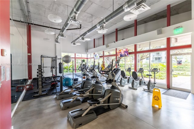 gym with a towering ceiling