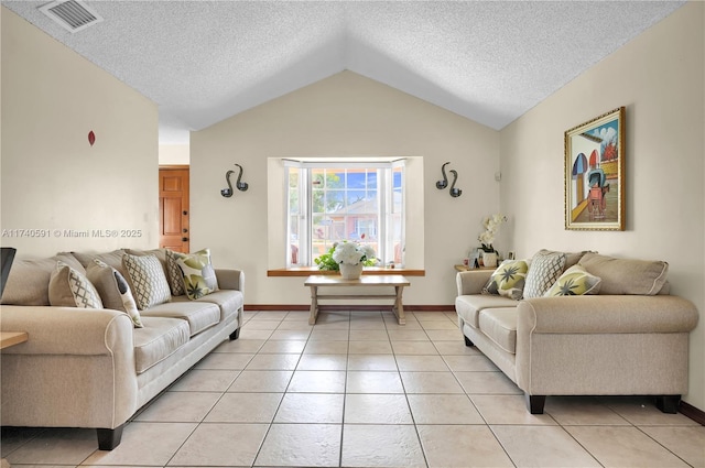 living room with light tile patterned floors, vaulted ceiling, and a textured ceiling