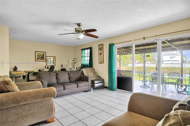 tiled living room featuring ceiling fan and a textured ceiling