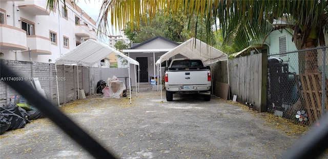 1260 NW 4th St, Miami, FL 33125 - view of vehicle parking featuring a detached carport and asphalt driveway
