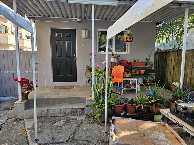 1260 NW 4th St, Miami, FL 33125 - doorway to property with a surveillance system and stucco siding