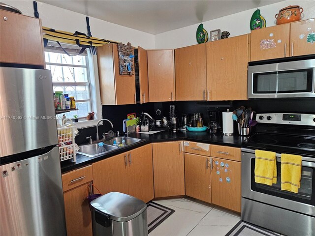 1260 NW 4th St, Miami, FL 33125 - kitchen with stainless steel appliances, a sink, and dark countertops