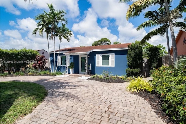 view of front of property with fence and stucco siding