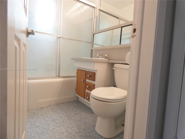 full bathroom with toilet and combined bath / shower with glass door