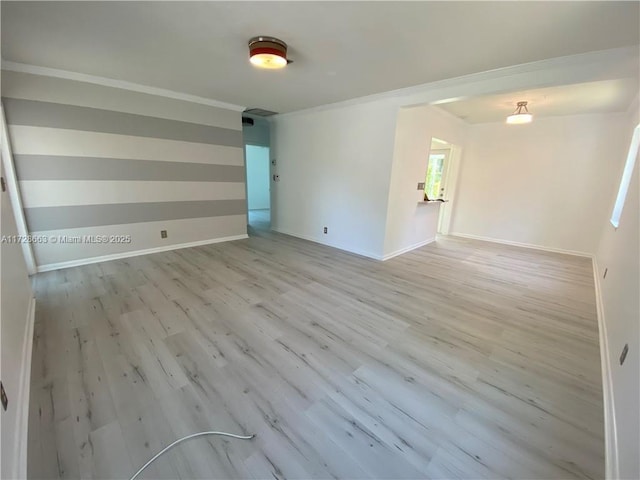 unfurnished room featuring light wood-style flooring and baseboards