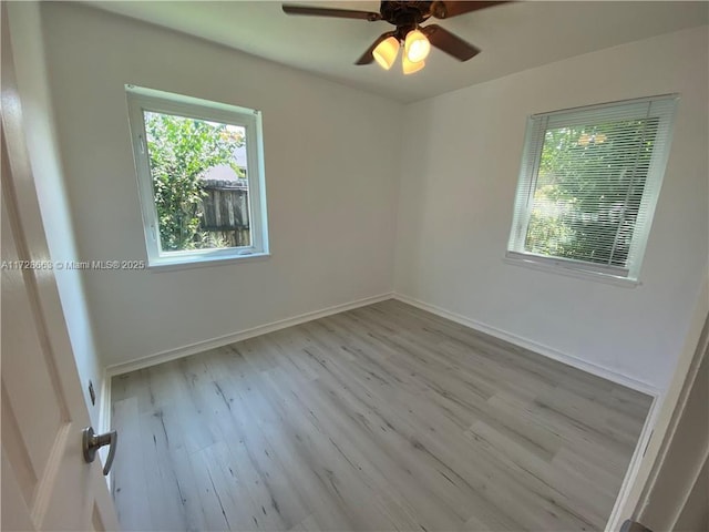 empty room with light wood-style flooring, baseboards, and ceiling fan