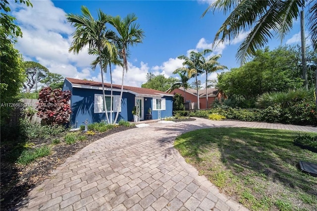 view of front of property with a front yard and fence