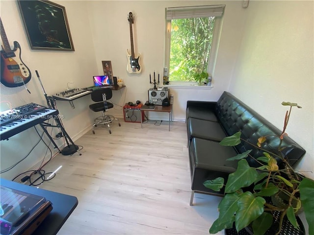 office area featuring light wood-style floors and baseboards