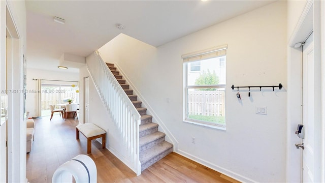 stairs featuring hardwood / wood-style flooring