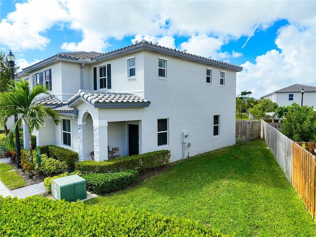 back of property featuring a lawn