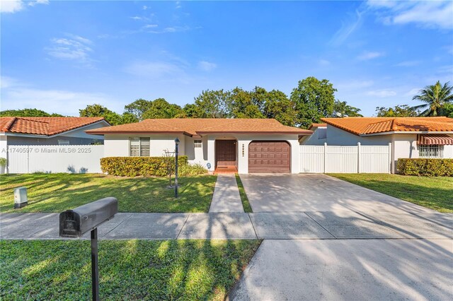 view of front of property featuring a garage and a front lawn