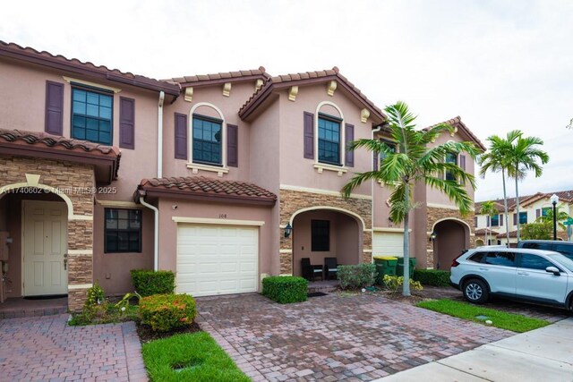 mediterranean / spanish-style home with a garage