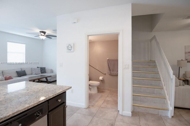 bathroom with ceiling fan, tile patterned floors, and toilet