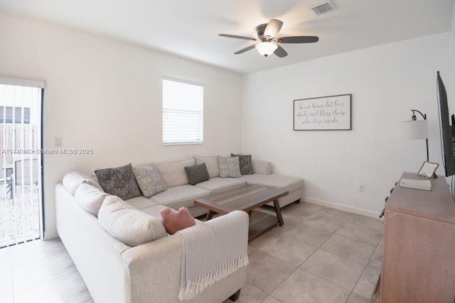 tiled living room featuring ceiling fan