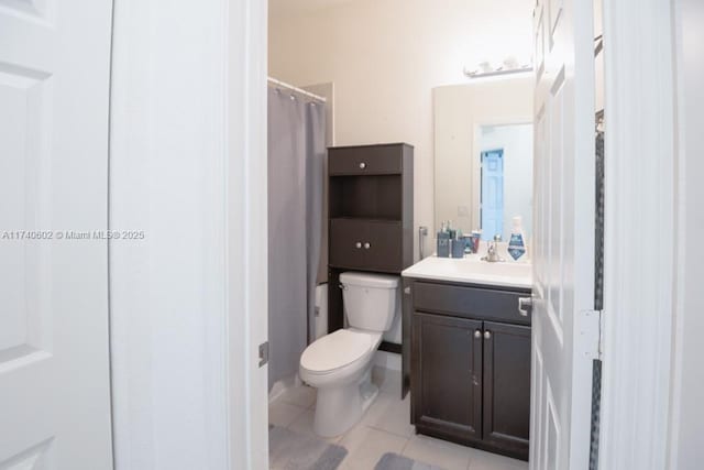 bathroom with vanity, a shower with shower curtain, tile patterned floors, and toilet