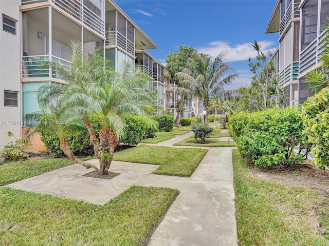 view of property's community with a lawn