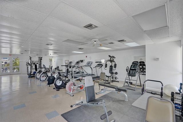 workout area with a drop ceiling and ceiling fan