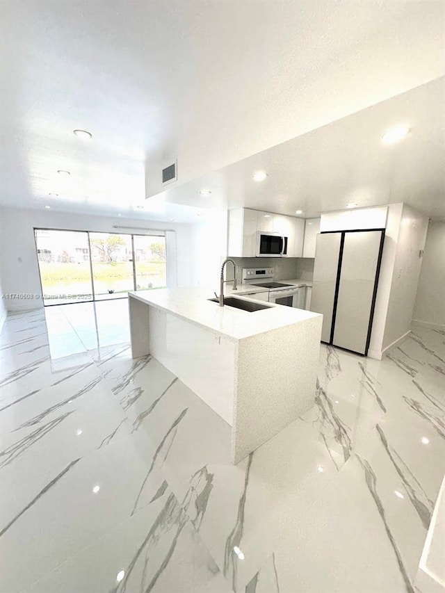 kitchen with white appliances, sink, and white cabinets