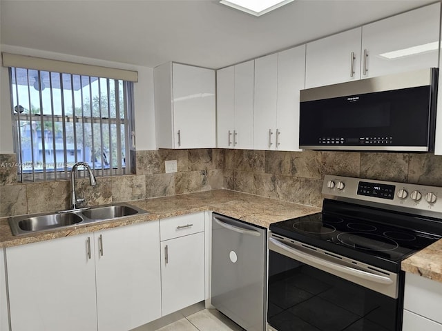 kitchen featuring white cabinetry, appliances with stainless steel finishes, and sink