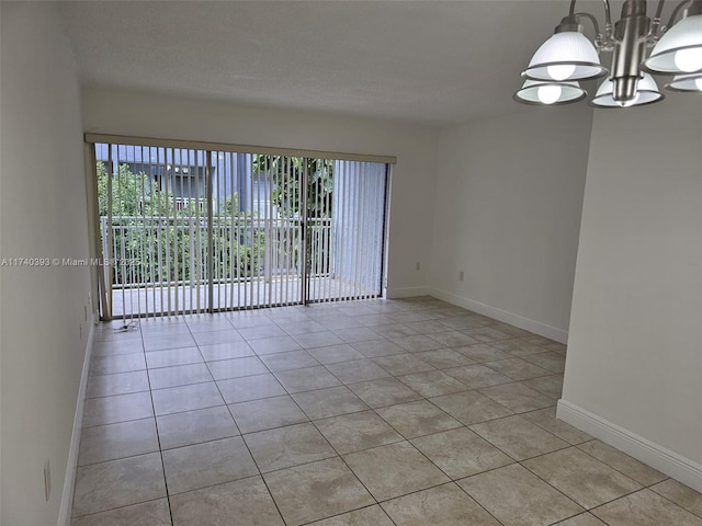 tiled empty room with a notable chandelier and a textured ceiling