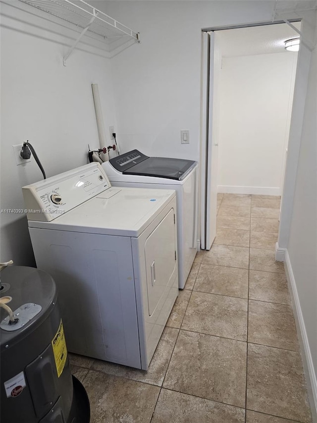 laundry area featuring washing machine and dryer and light tile patterned flooring