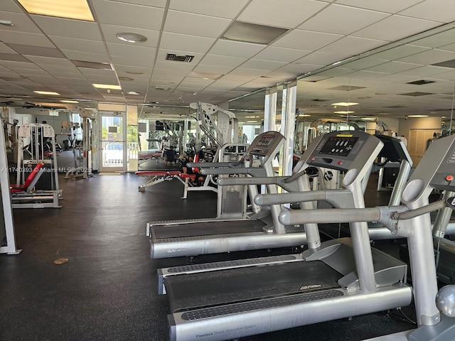 workout area with a paneled ceiling