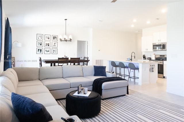 living room with sink and a chandelier