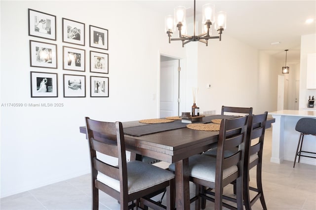 dining area with light tile patterned floors and an inviting chandelier