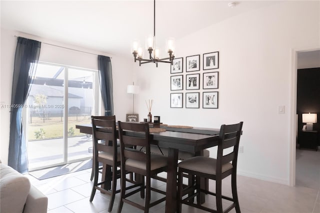 dining space with light tile patterned floors, baseboards, and a notable chandelier