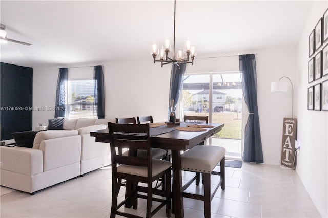 dining room with light tile patterned floors and an inviting chandelier