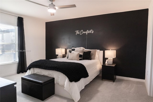 bedroom featuring light carpet and ceiling fan