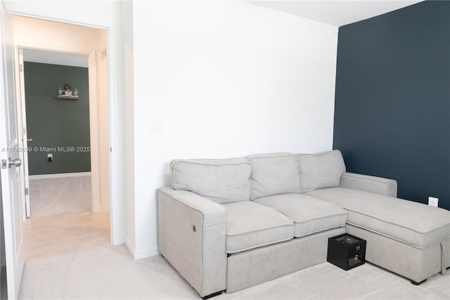 living room featuring light carpet and baseboards