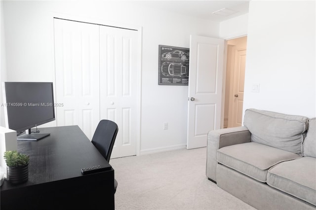 office space with baseboards and light colored carpet