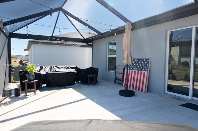 view of patio / terrace featuring glass enclosure