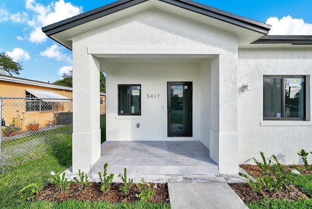 doorway to property with a patio area