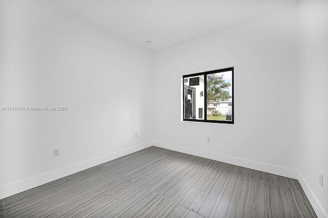 unfurnished room featuring dark wood-type flooring