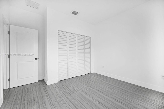 unfurnished bedroom featuring hardwood / wood-style floors and a closet