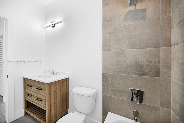 bathroom with a tub to relax in, vanity, and toilet