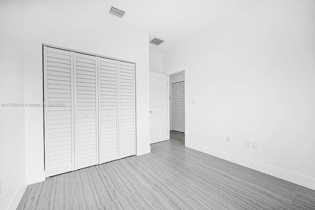 unfurnished bedroom with a closet