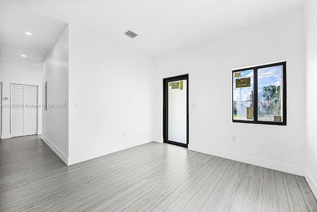 empty room with hardwood / wood-style floors